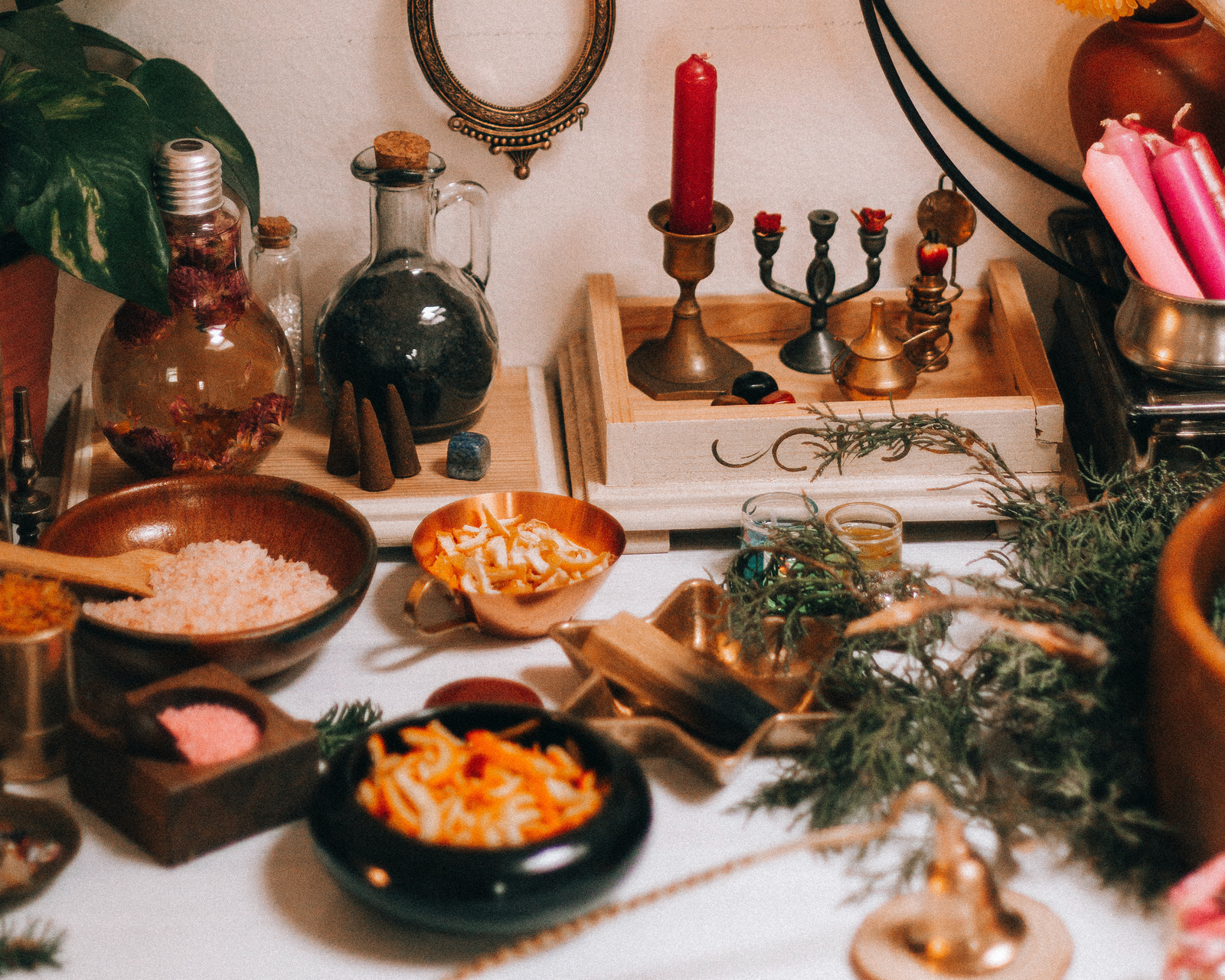 in this picture you can see a kitchen witchery, a lot of herbs, spices, fruits, candles and everything else you need to make a magical simmer pot.