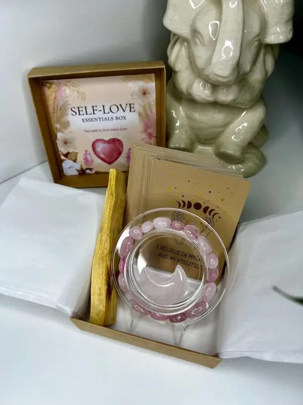 Self-Love Essentials Box featuring Rose Quartz Bracelet, Moon Gemstone, Palo Santo Stick, and Affirmation Cards for self-compassion and inner peace.